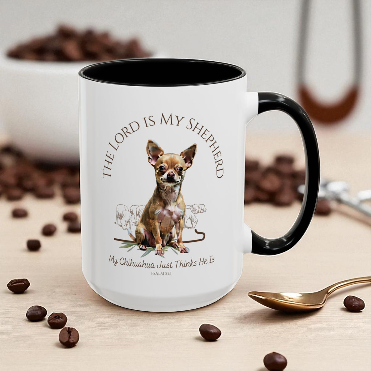 White mug with black interior, featuring a dog illustration and text, on a table with coffee beans and a spoon.