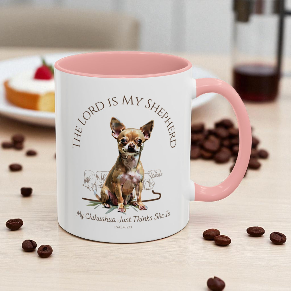 Mug with a dog illustration and text on a table with coffee beans and a plate of food.