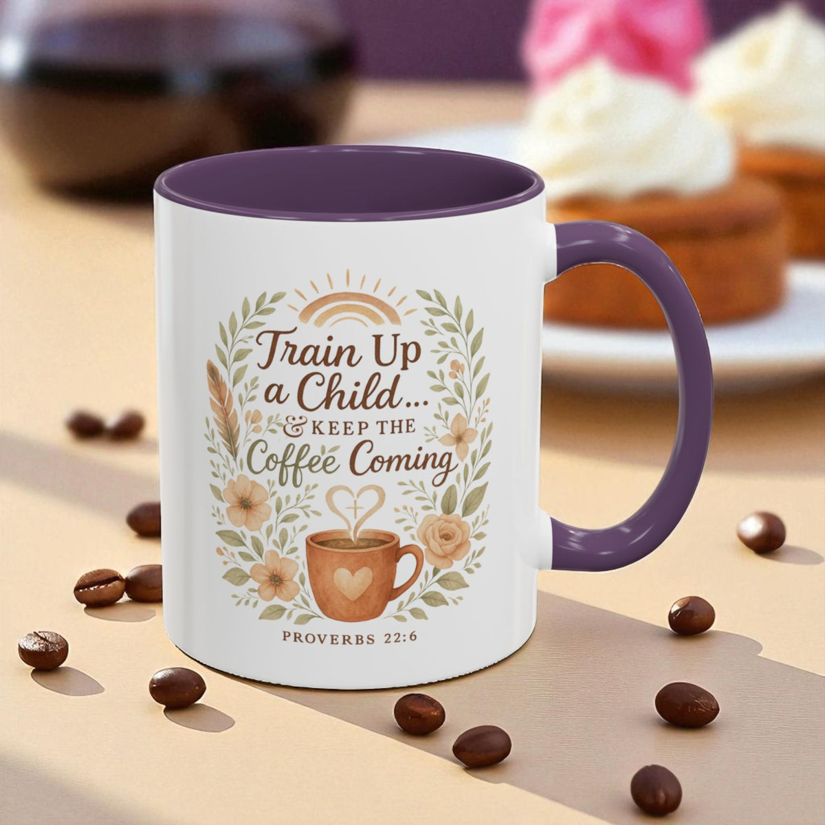 Mug with decorative text and design on a table with coffee beans and pastries