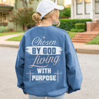 Person wearing a blue sweatshirt with a motivational quote outdoors.