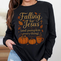 Black long sleeve shirt with 'Falling for Jesus (and pumpkin everything)' text and graphics worn by a person.