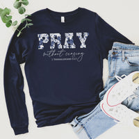 Navy blue sweatshirt with 'PRAY without ceasing' text, paired with jeans and sneakers on a light background.
