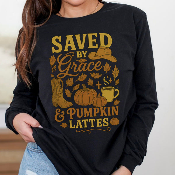 Black long-sleeve shirt with gold graphic and text 'Saved by Grace & Pumpkin Lattes' worn by a person.