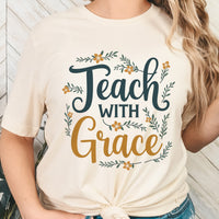 Person wearing a white t-shirt with 'Teach with Grace' text and floral designs.