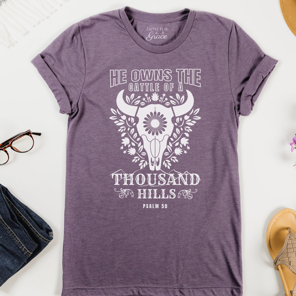 Purple t-shirt with white graphic and text on a white background