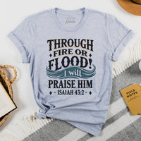 Light blue t-shirt with motivational quote on a white surface with books and a hat.