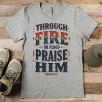 Gray t-shirt with motivational quote on a wooden surface with shoes and a cap.