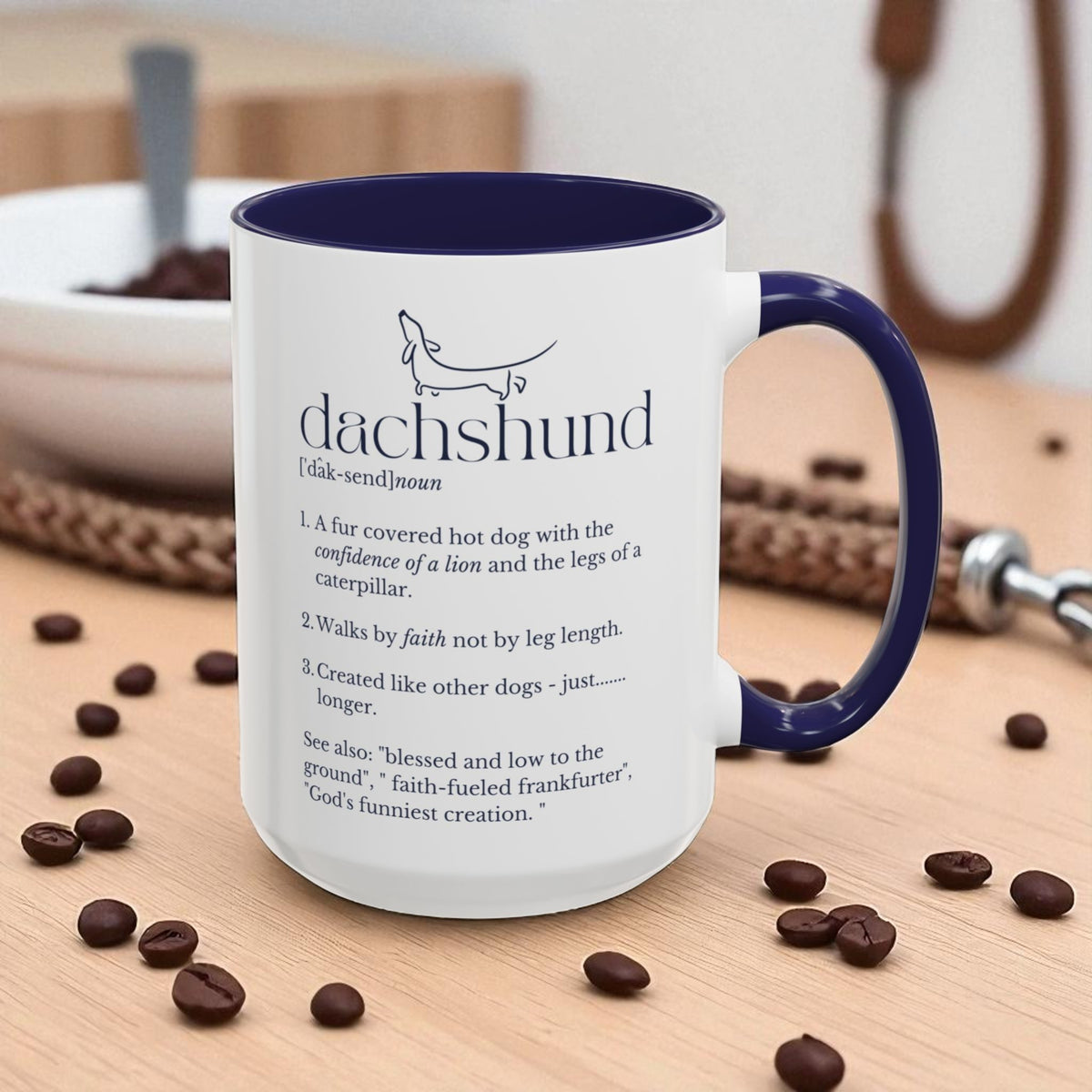 Mug with dachshund definition on a table with coffee beans