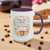 Mug with 'Train Up a Child... and Keep the Coffee Coming' design on a wooden surface with coffee beans.