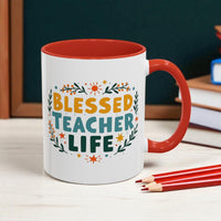 Mug with 'Blessed Teacher Life' text on a desk with books and pencils.