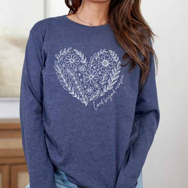 Blue long sleeve shirt with a floral heart design on a neutral background