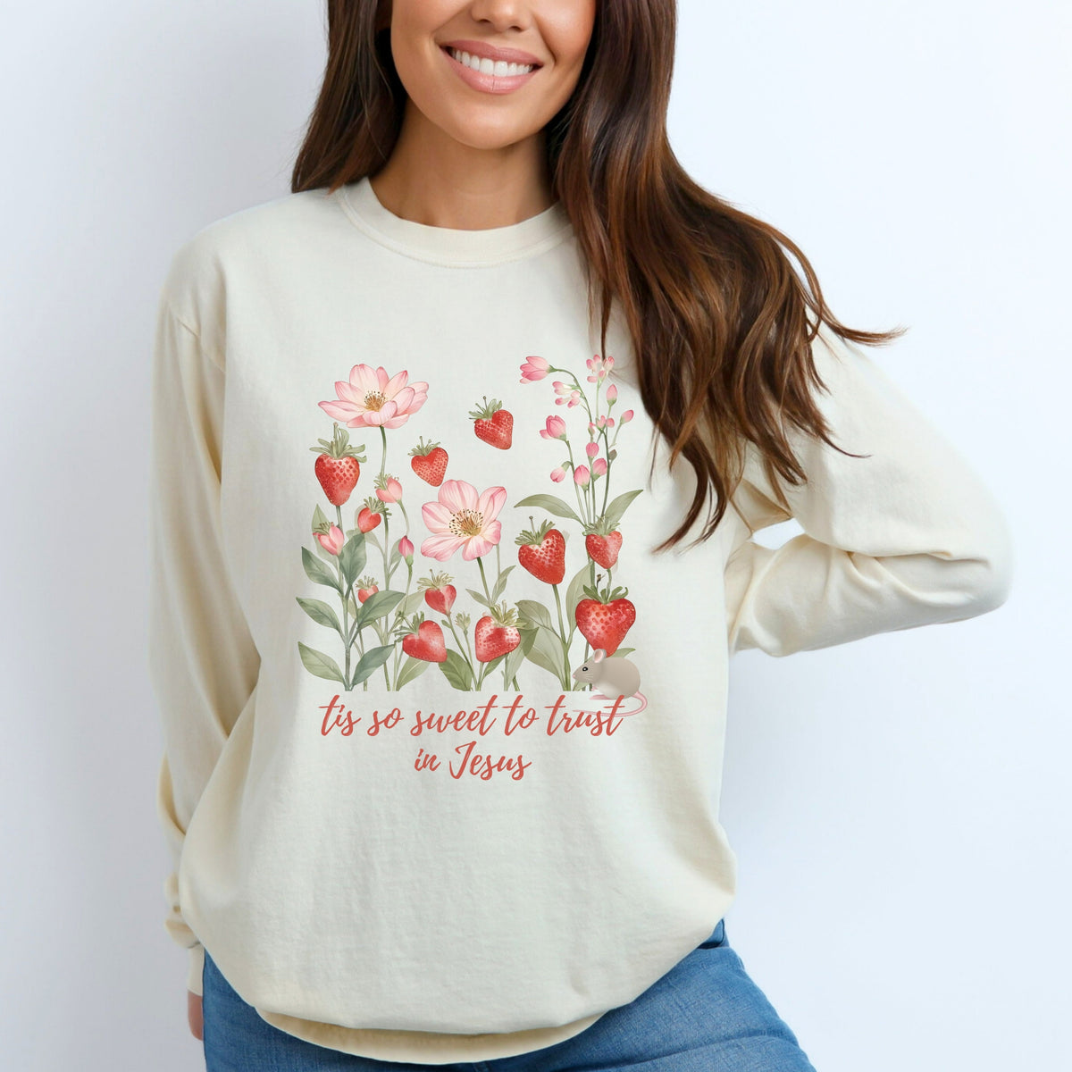 Woman wearing a cream long sleeve tee with floral design and text on a white background