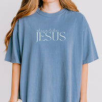 Person wearing a blue t-shirt with 'Shine Like Jesus' text on a plain background