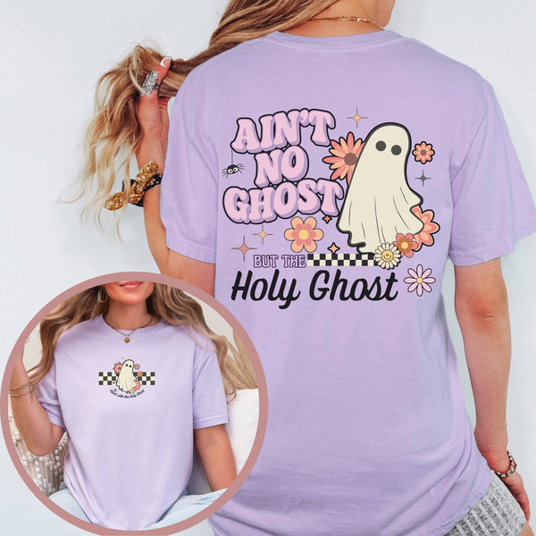 Person wearing a purple t-shirt with a ghost graphic and text, on a plain background.