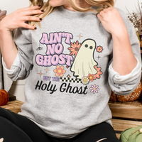 Person wearing a gray sweatshirt with a ghost graphic and text.
