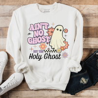 White sweatshirt with ghost graphic and text on a wooden surface with shoes and jeans.