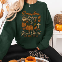 Person wearing a green sweatshirt with 'Pumpkin Spice & Jesus Christ' text and pumpkin design.