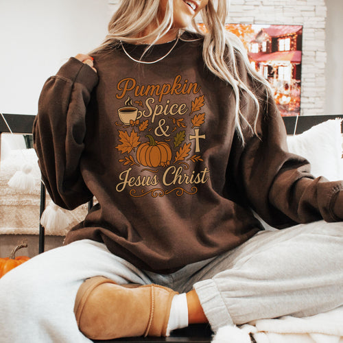 Person wearing a brown sweatshirt with 'Pumpkin Spice & Jesus Christ' text and graphics.