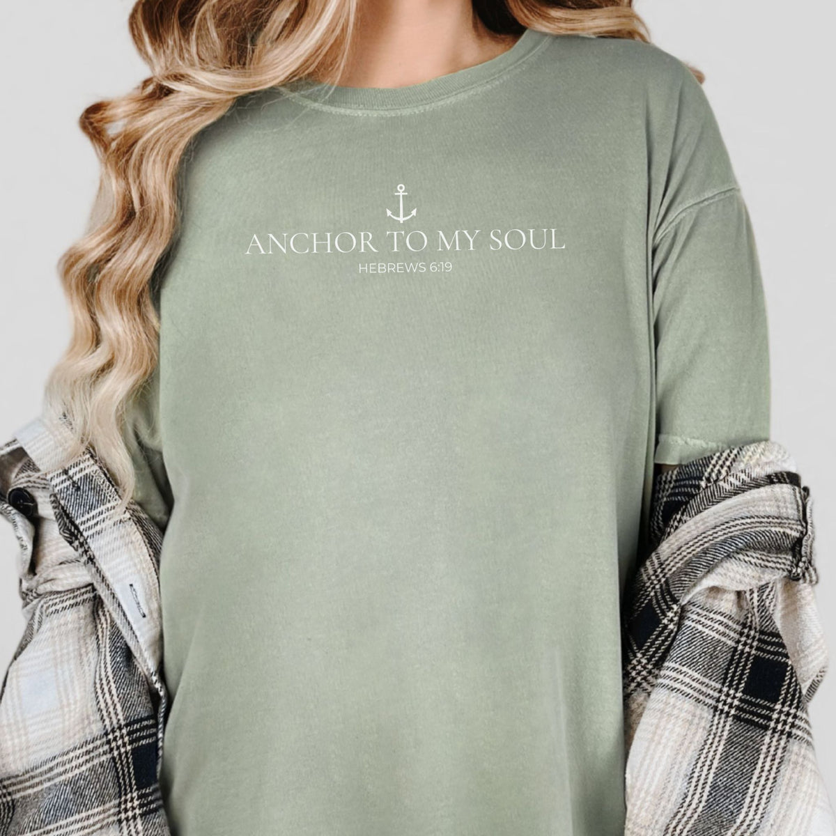 Person wearing a green shirt with 'Anchor to My Soul' text and anchor graphic.