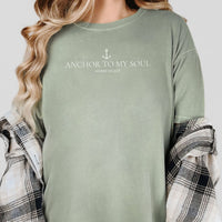 Person wearing a green shirt with 'Anchor to My Soul' text and anchor graphic.
