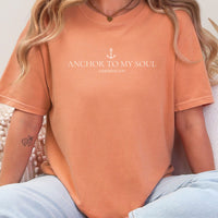 Person wearing an orange t-shirt with 'Anchor to My Soul' text and anchor symbol.