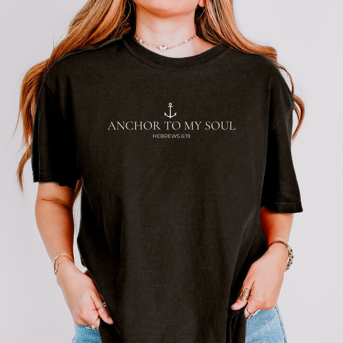 Person wearing a black t-shirt with 'Anchor to My Soul' text and anchor symbol.