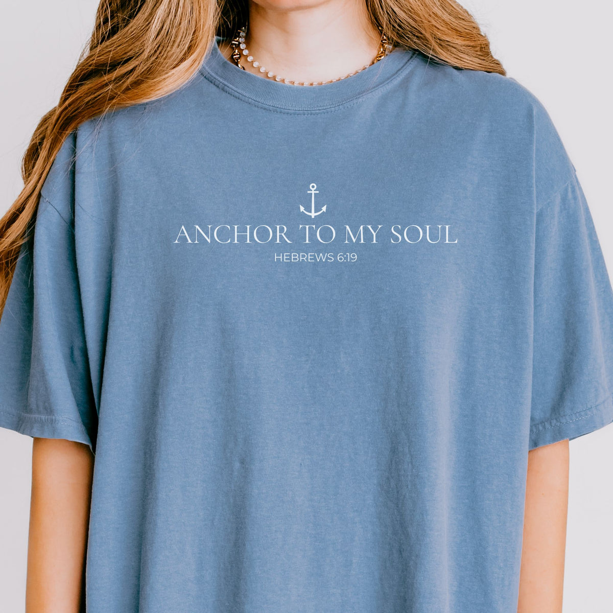 Blue t-shirt with 'Anchor to My Soul' text and anchor graphic on a plain background