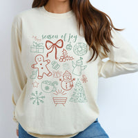 Beige long sleeve tee with Christmas-themed graphics worn by a person on a white background