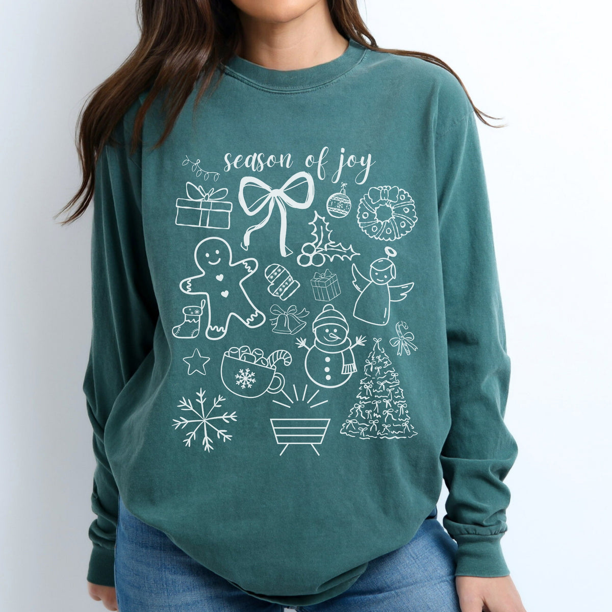 Green long sleeve tee with Christmas-themed designs and 'season of joy' text on a white background