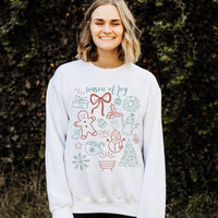Person wearing a white sweatshirt with Christmas-themed designs and text.