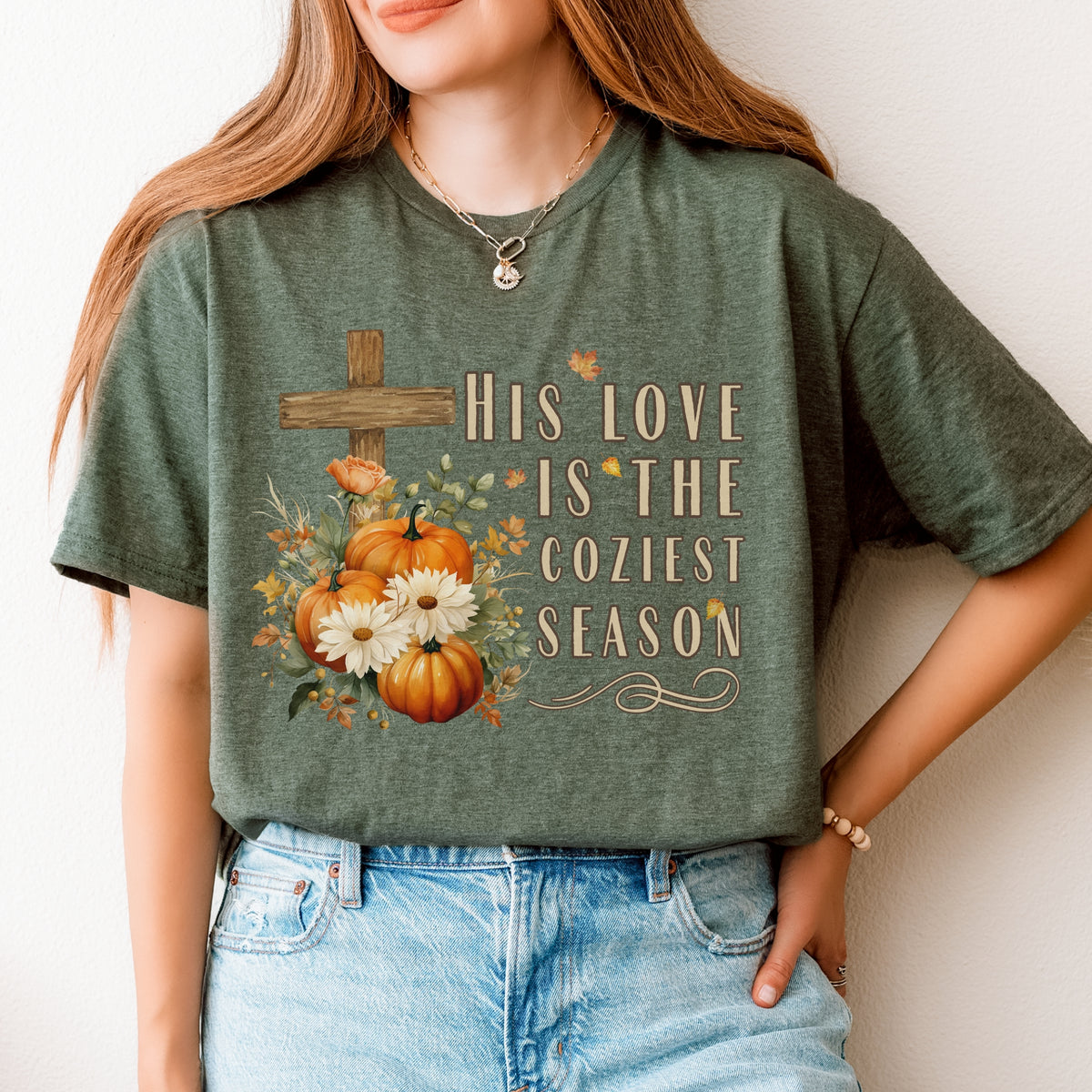 Person wearing a green t-shirt with a fall-themed design and text.