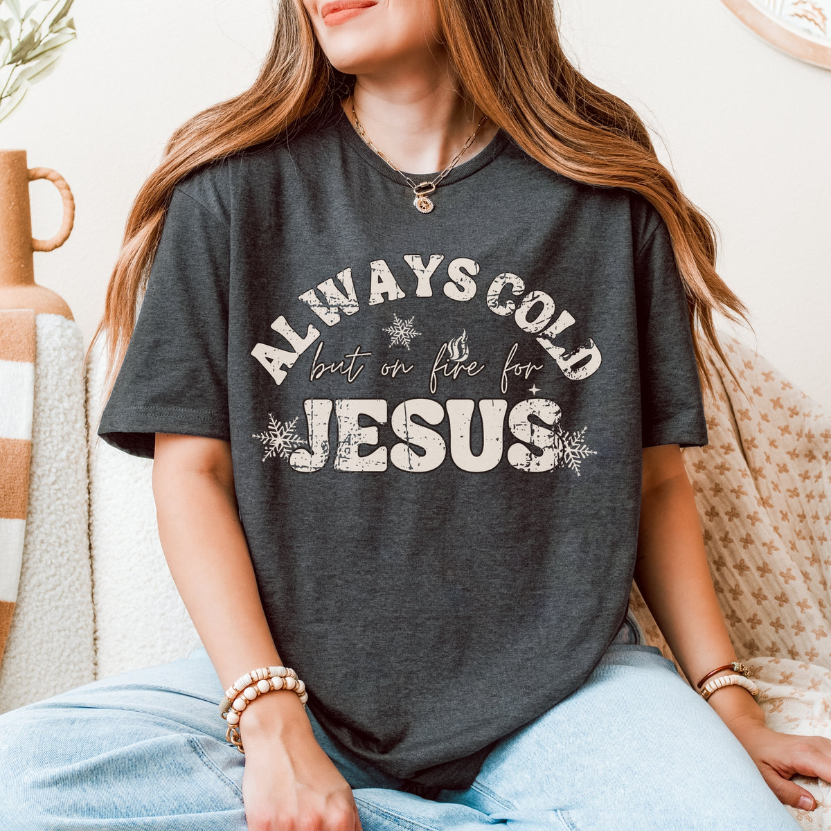 Person wearing a dark gray t-shirt with 'Always Cold but on fire for Jesus' text.