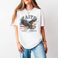 Person wearing a white t-shirt with an eagle graphic and text on a plain background