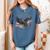 Person wearing a blue t-shirt with an eagle graphic and text in a home setting