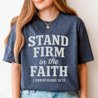 Person wearing a blue t-shirt with 'Stand Firm in the Faith' text
