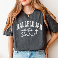 Person wearing a dark gray t-shirt with 'HALLELUJAH what a Savior' text and cross symbol.
