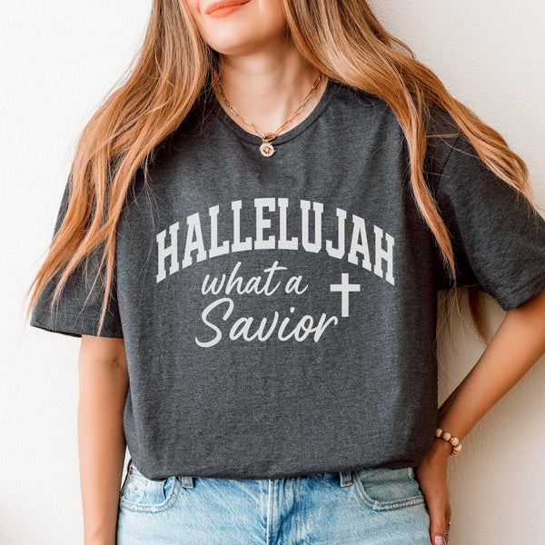 Person wearing a dark gray t-shirt with 'HALLELUJAH what a Savior' text and cross symbol.