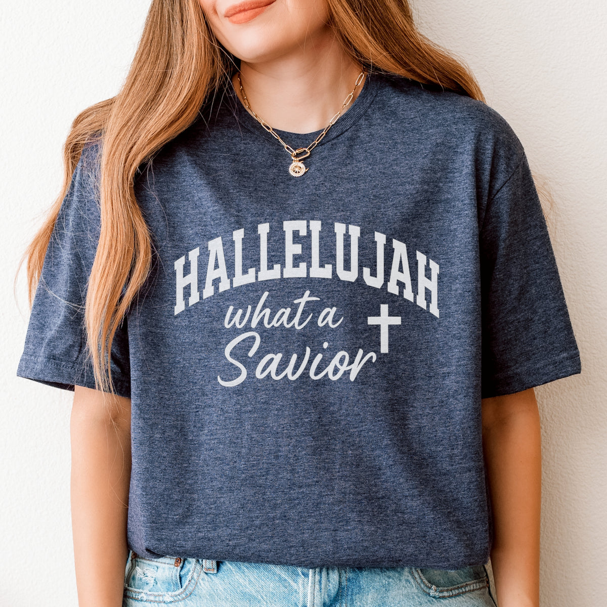 Person wearing a blue t-shirt with 'HALLELUJAH what a Savior' text and cross symbol.