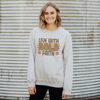 Person wearing a gray sweatshirt with 'Live with Bold Faith' text against a corrugated metal background