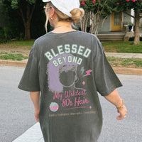 Person wearing a t-shirt with 'Blessed Beyond My Wildest 80's Hair' design outdoors.