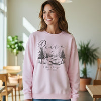 Woman wearing a pink sweatshirt with a nature-themed design and text in a casual indoor setting.