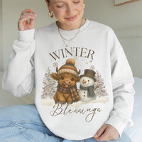 Person wearing a white sweatshirt with a winter-themed design featuring a cow and snowman, text 'Winter Blessings'.