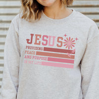Person wearing a gray sweatshirt with a colorful text design.