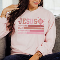 Person wearing a pink sweatshirt with a message about Jesus