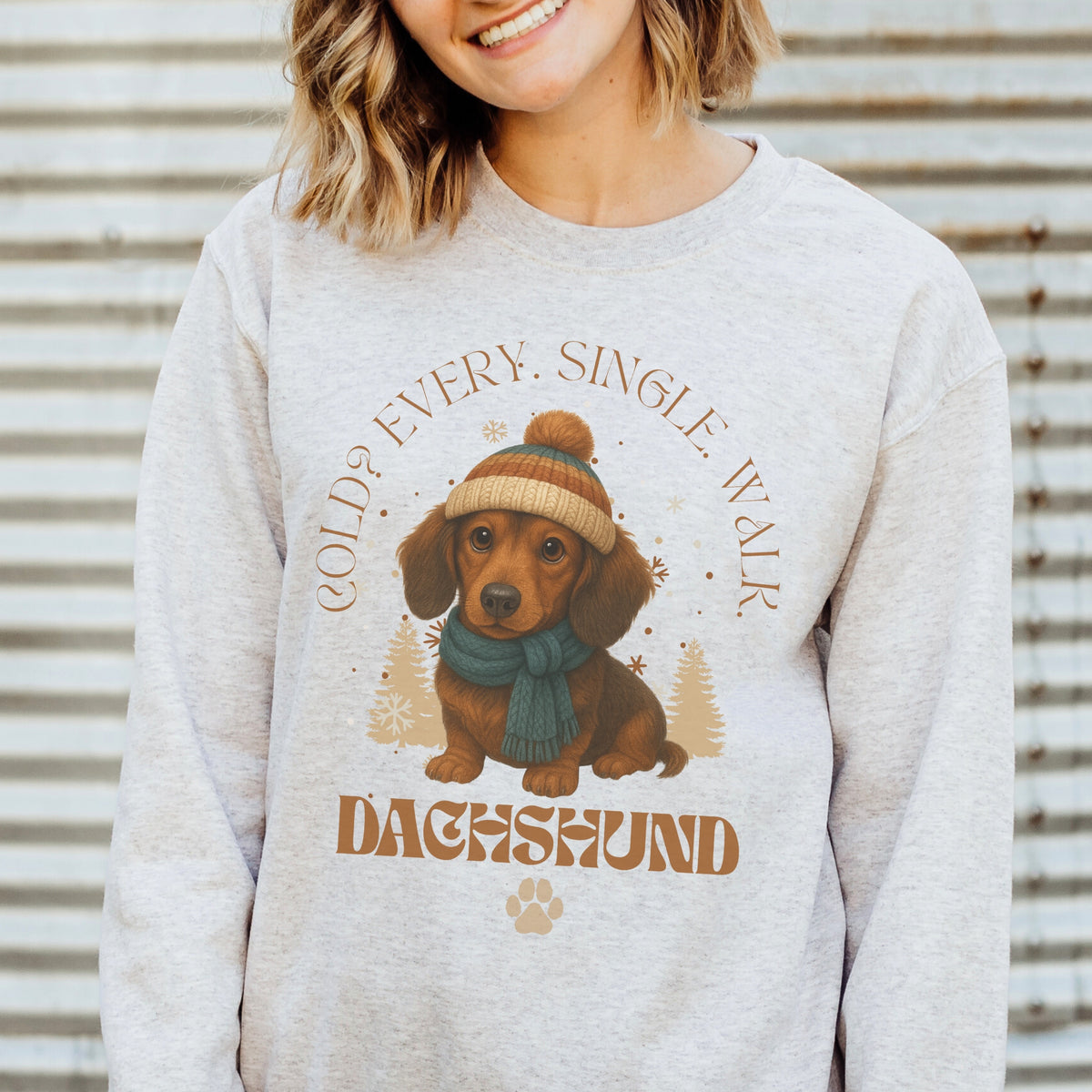 Person wearing a sweater with a dachshund graphic and text