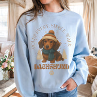 Light blue sweatshirt with dachshund graphic and text in a home setting