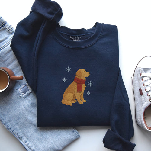 Navy blue sweatshirt with a dog design on a white surface with jeans and a shoe.