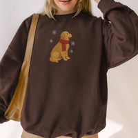 Person wearing a brown sweatshirt with a dog design and a red scarf.