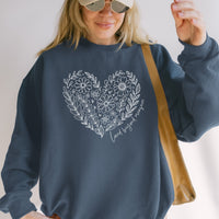 Person wearing a navy blue sweatshirt with floral heart design and sunglasses