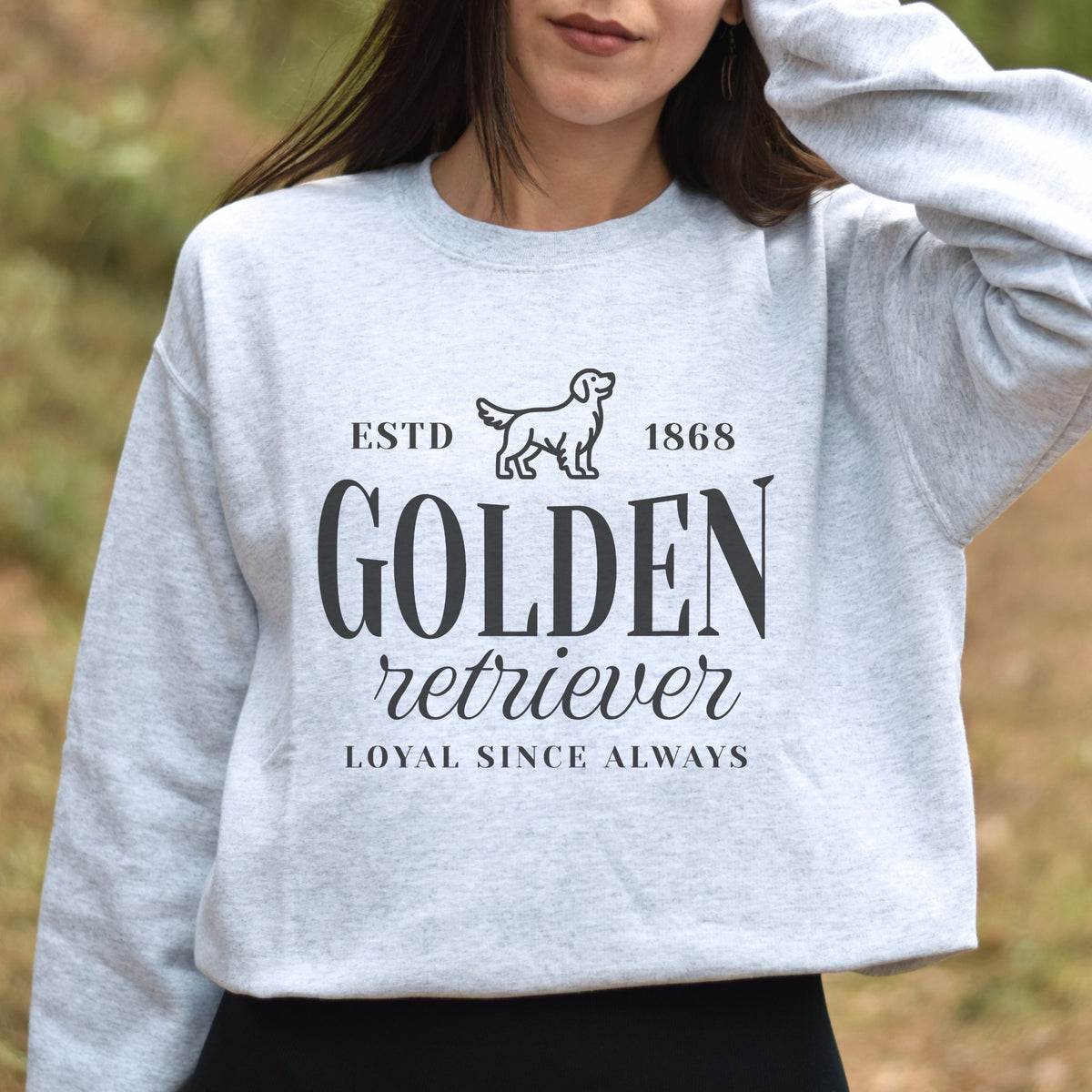 Person wearing a gray sweatshirt with 'Golden Retriever Loyal Since Always' text and logo.
